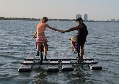 Couple riding a water bike on a water lake - miami-waterbikes.com