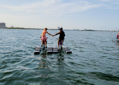 Couple riding a water bike on a water lake - miami-waterbikes.com